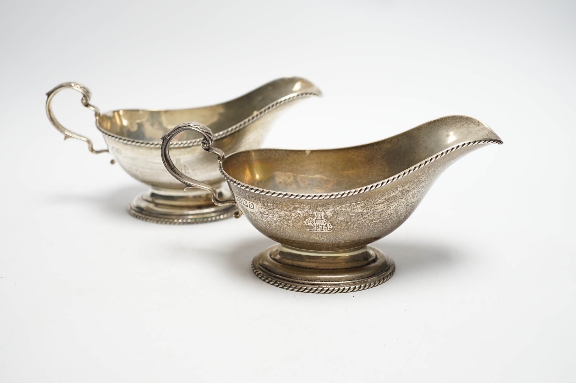 A pair of George V silver oval pedestal sauceboats, London, 1917, 19cm length, 10.6oz.